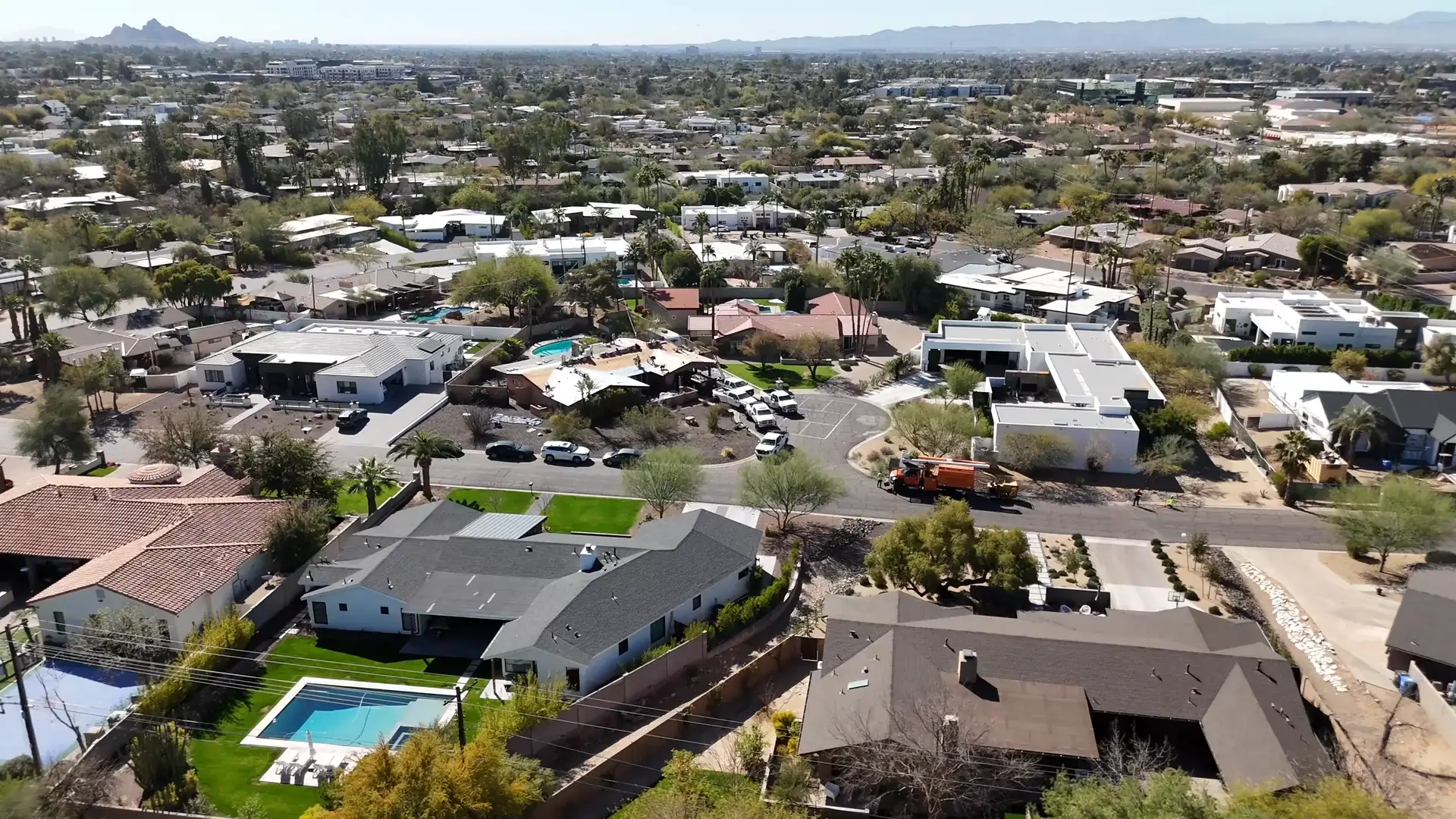 Aerial view of Arizona suburban neighborhood with desert homes and mountain backdrop