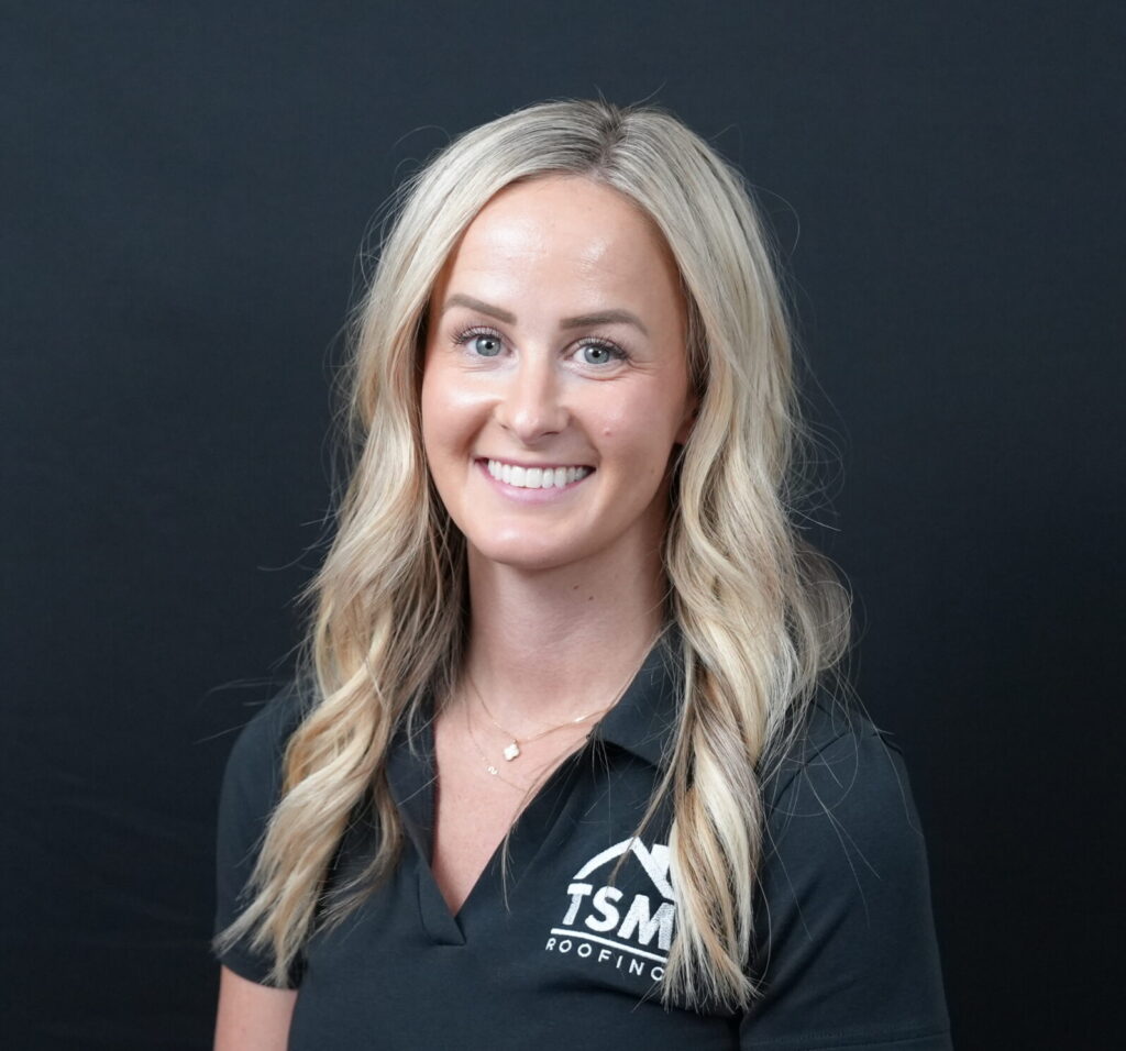 Professional blonde woman smiling in TSM Roofing company polo shirt headshot