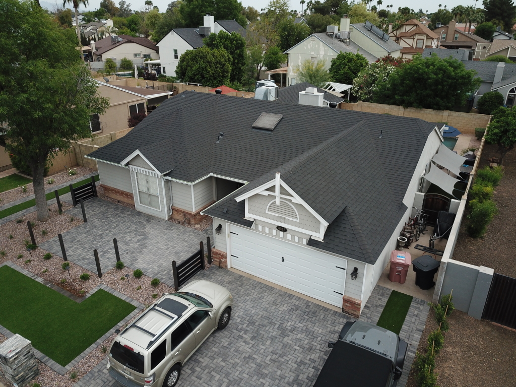 a house with a driveway and cars parked in front of it