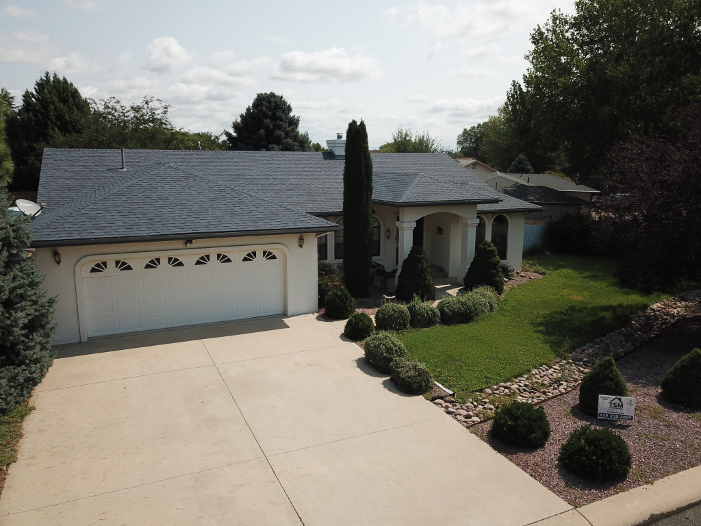 a house with a driveway and a lawn