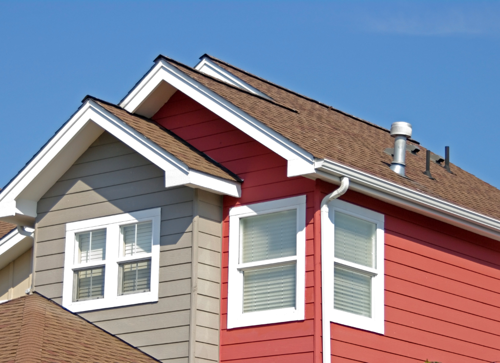 a house with red siding and white windows